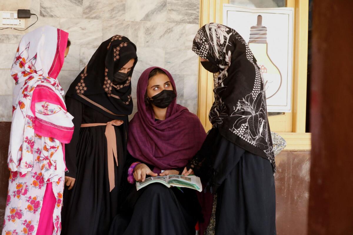 Afghan girls chat with each other after they attended a class at the Skills Academy for Needy Aspirants (SANA) in Peshawar, Pakistan,  on August 9. — Reuters