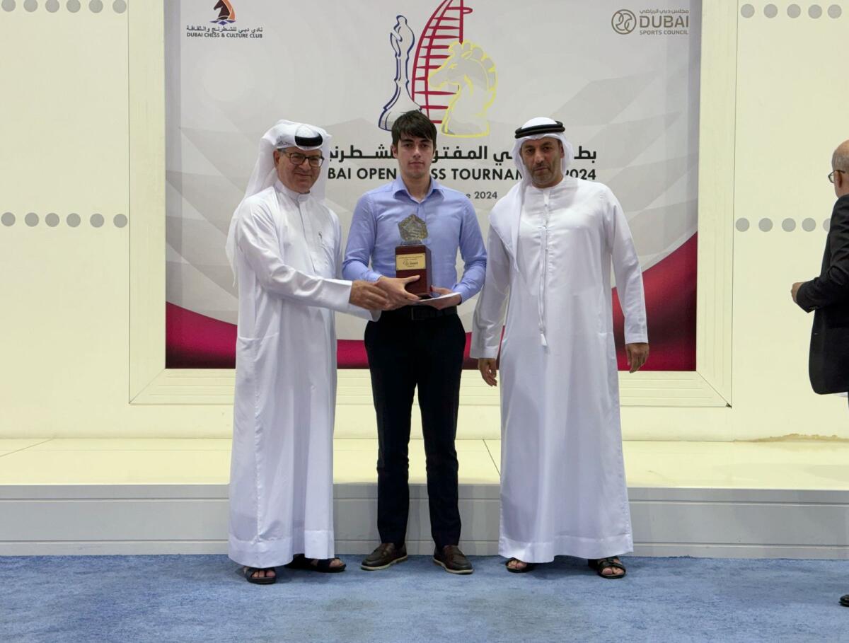 Grandmaster Mahammad Muradli (centre) receives the trophy. — Supplied photo