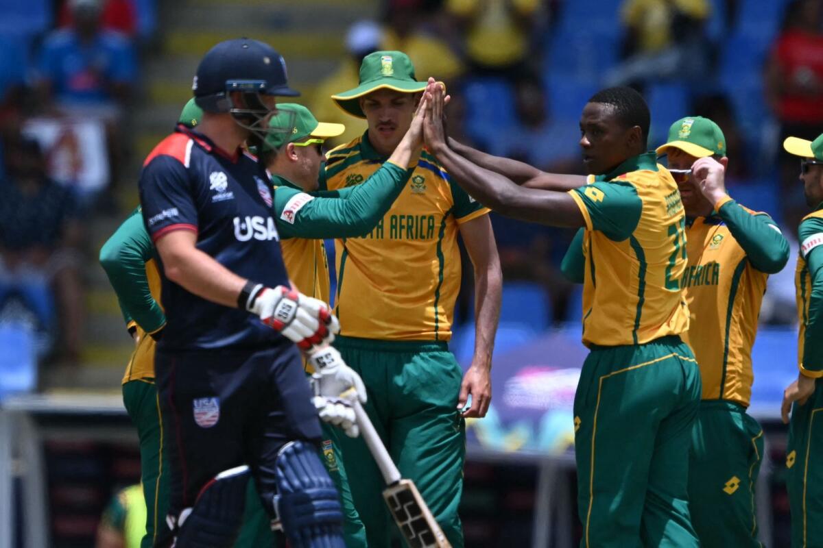 South African players celebrate the wicket of USA's Steven Taylor. — AFP