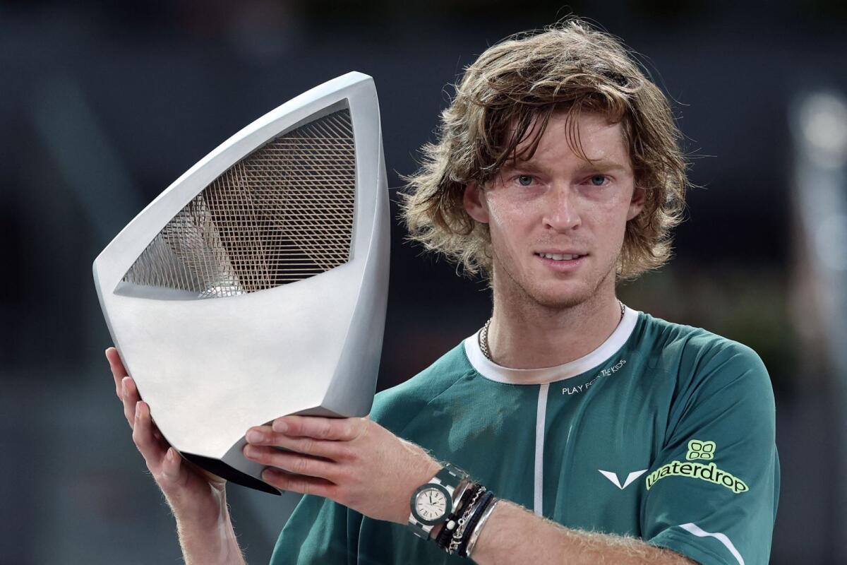 Russia's Andrey Rublev holds his trophy after winning the 2024 ATP Tour Madrid Open. — AFP