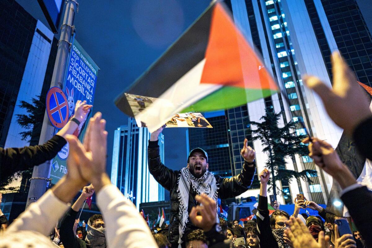 A protesters shouts slogans and wave a  Palestinian flag during a rally in support of Palestinians in Istanbul on October 18, 2023. Photo: AFP