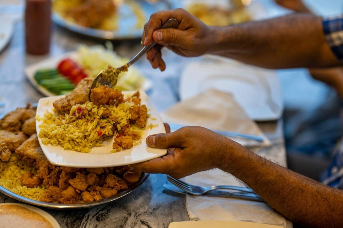 Clients are served traditional Sudanese food at a restaurant run by a businesswoman who relocated to the Egyptian capital Cairo after fleeing the ongoing war in Sudan on May 21, 2024.  — AFP