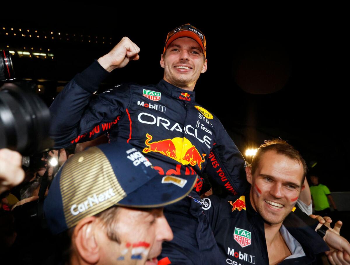 Red Bull's Max Verstappen celebrates winning the race and the championship with his team. (Reuters)