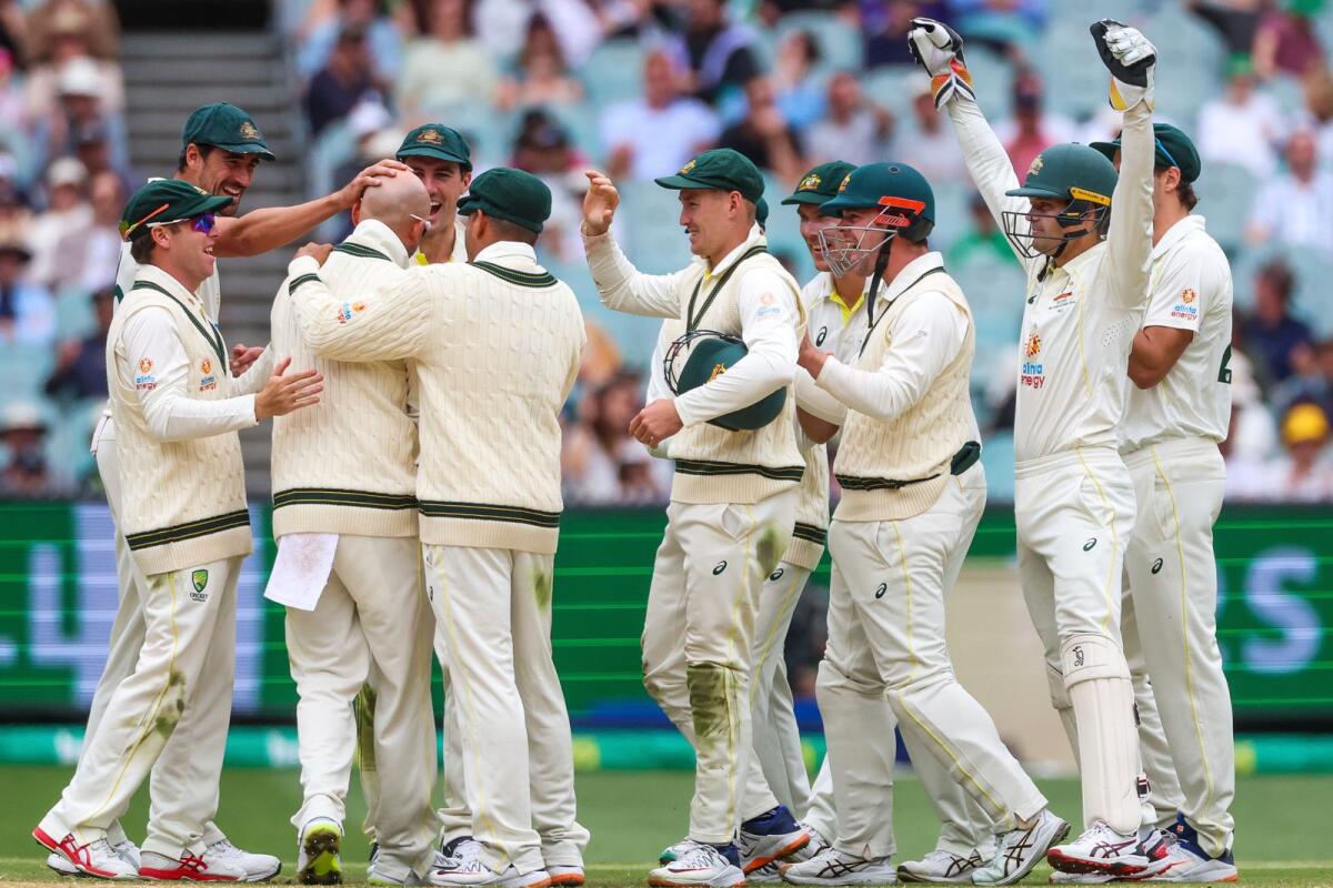 Australian players celebrate after Australia's Nathan Lyon gets the wicket of South Africa's Marco Jansen. -- AP