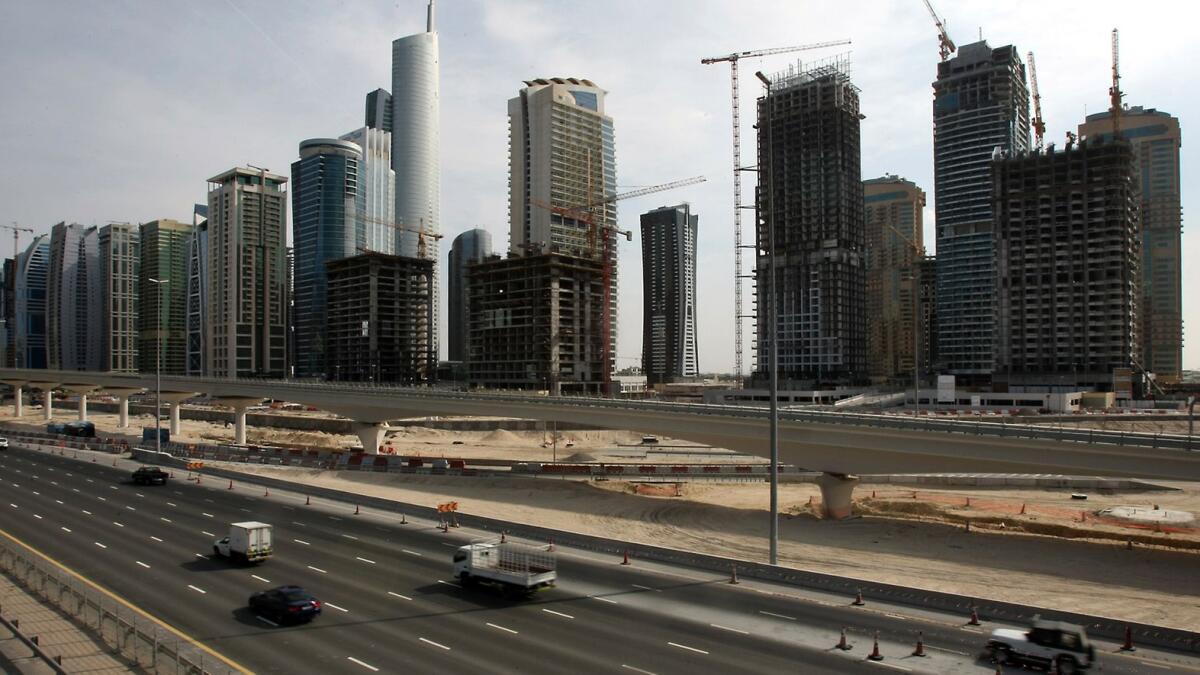 Cars drive through the Sheikh Zayed road in Dubai. The broad range of trade credit insurance amongst these two entities will help anticipate and mitigate risks they might encounter due to various political, commercial, and non-commercial reasons. — AFP file photo 