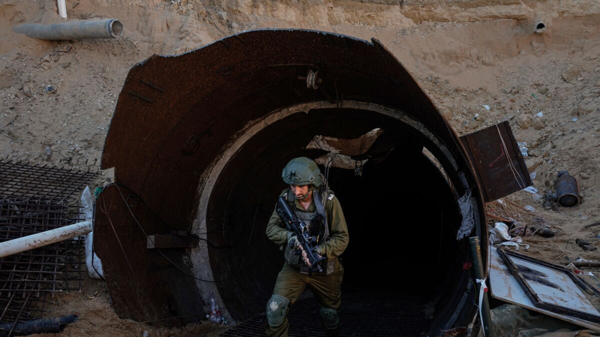 Israeli soldiers exit a tunnel that the military says Hamas militants used to attack the Erez crossing in the northern Gaza Strip. — AP