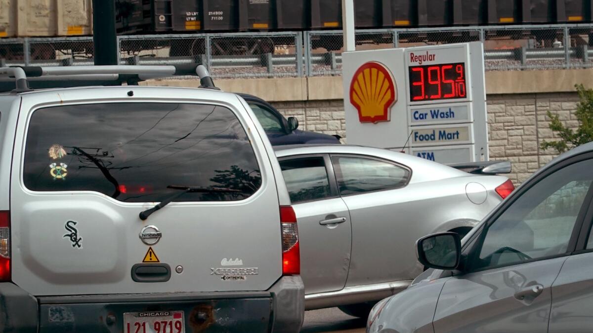Gas prices are displayed at a Shell gas station in Bensenville, Illinois. According to a survey from the New York Federal Reserve, falling gas prices are raising optimism that inflation is on the decline. — AFP