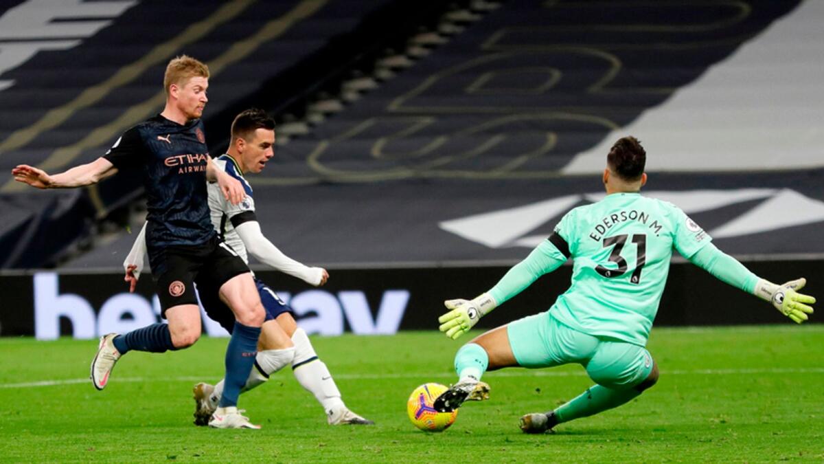 Tottenham Hotspur's  Giovani Lo Celso (second left) scores past Manchester City's goalkeeper Ederson during the English Premier League match on Saturday. — AFP