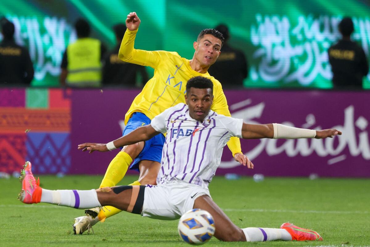 Al Ain's Emirati defender Saeed Juma fights for the ball with Al Nassr's Portuguese forward Cristiano Ronaldo during the match in Riyadh. — AFP