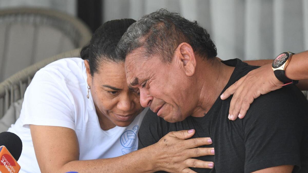 Luis Manuel Diaz (right) is consoled by his wife Cilenis Marulanda during a press conference at his house in Barrancas, Colombia on Friday. — AFP