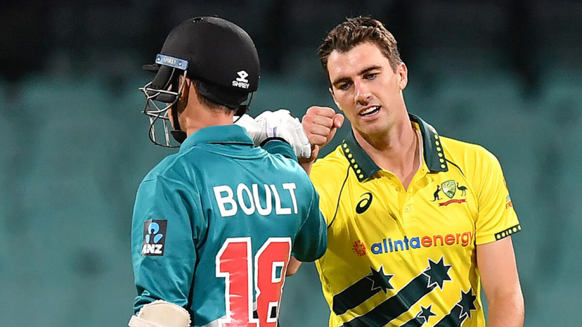 Australia's Pat Cummins gives a fist bump to New Zealand's batsman Trent Boult during the first ODI. The series was abandoned on Saturday due to Covid-19 fears. - AFP