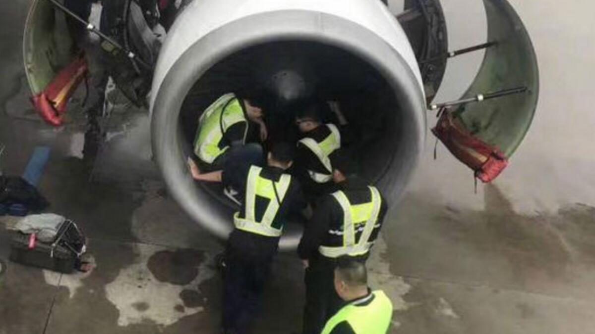 Woman throws coins into engine for good luck, delays flight