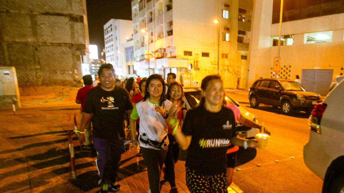 Participants of RunMadan running in the Old Souq area towards the Grand Mosque