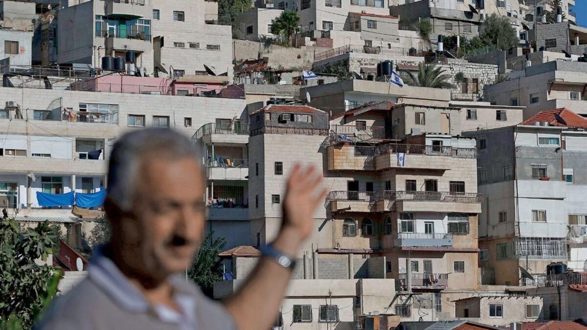 Israeli settlers plant  flags on Arab home