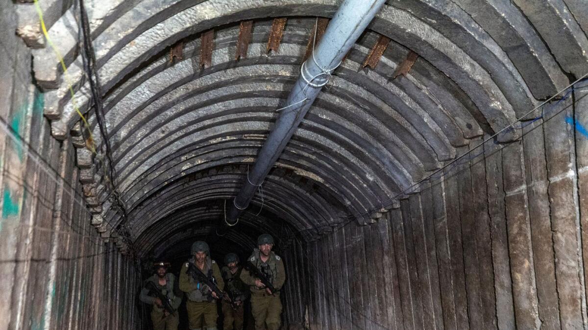 Israeli soldiers walk through what Israel's military says is an iron-girded tunnel designed by Hamas to disgorge carloads of Palestinian fighters for a surprise storming of the border close to Erez crossing in the northern Gaza Strip. — Reuters