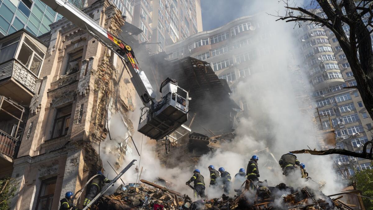 Firefighters work after a drone attack on buildings in Kyiv, Ukraine, on October 17, 2022.— AP