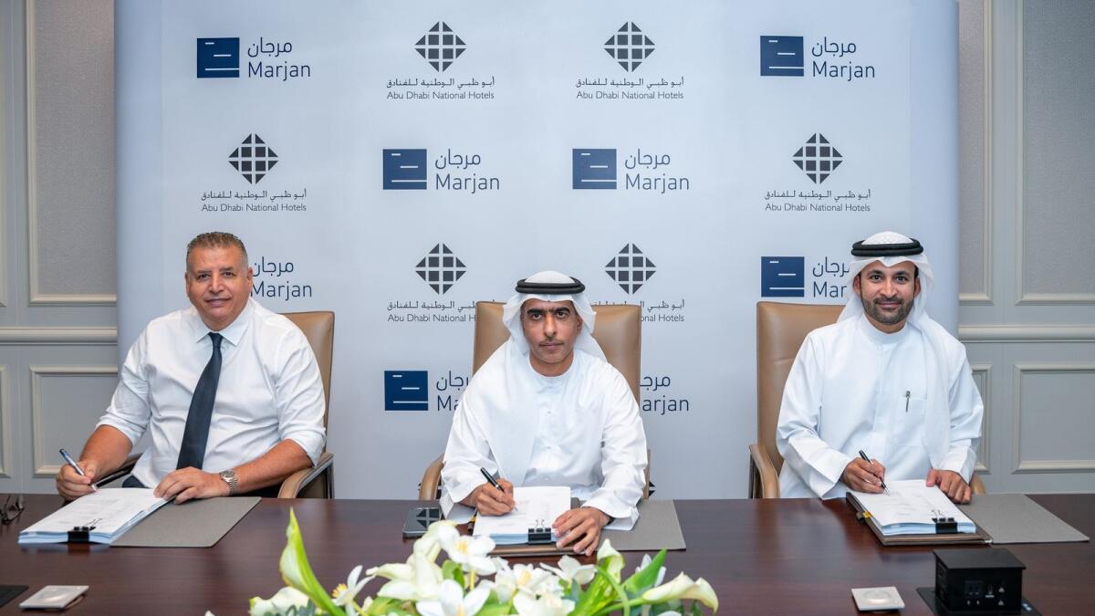 From left: Khalid Anib, CEO of ADNH; Sheikh Ahmed Aldhaheri, vice-chairman and MD, ADNH and Abdulla Al Abdooli, CEO of Marjan, at the signing ceremony. — Supplied photo