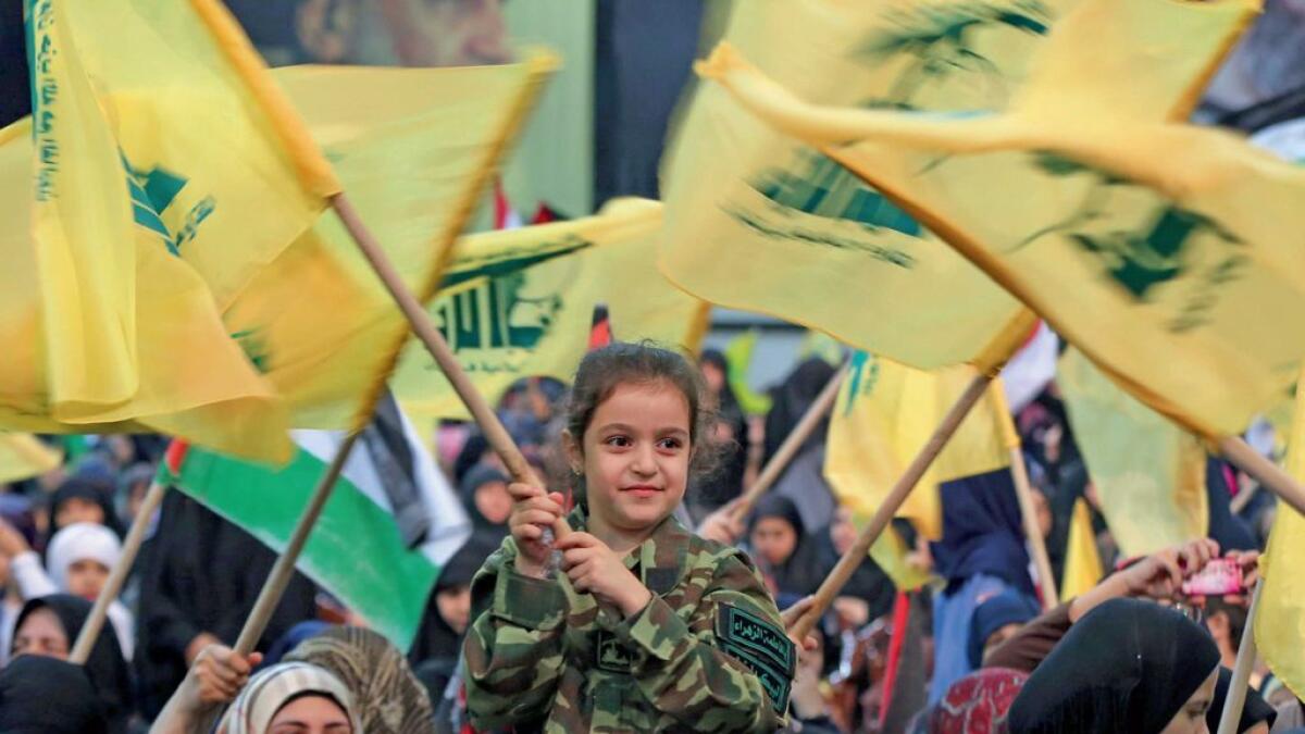 A Lebanese girl waves a Hezbollah flags during a rally to mark Al Quds (Jerusalem) day in the southern suburb of Beirut, Lebanon. 