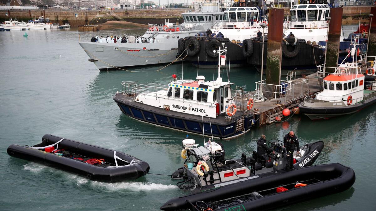 Members of Britain's Border Force tow into the Port of Dover an inflatable boat used by migrants who were rescued while crossing the English Channel in Dover, Britain, on April 14, 2022. — Reuters