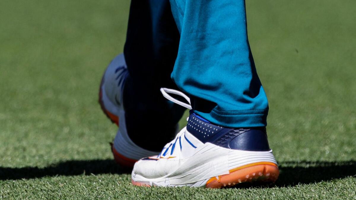 Australia's Usman Khawaja is seen on the field with a tape strapped on his left shoe to hide a message of support for people in Gaza, having been told it is against ICC rules, before the first day of the first Test against Pakistan in Perth on Thursday. Photo: AFP