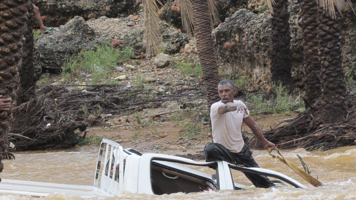 A man gestures as he tries to save a vehicle swept away by flood waters in Yemen's island of Socotra November 2, 2015. Reuters photo