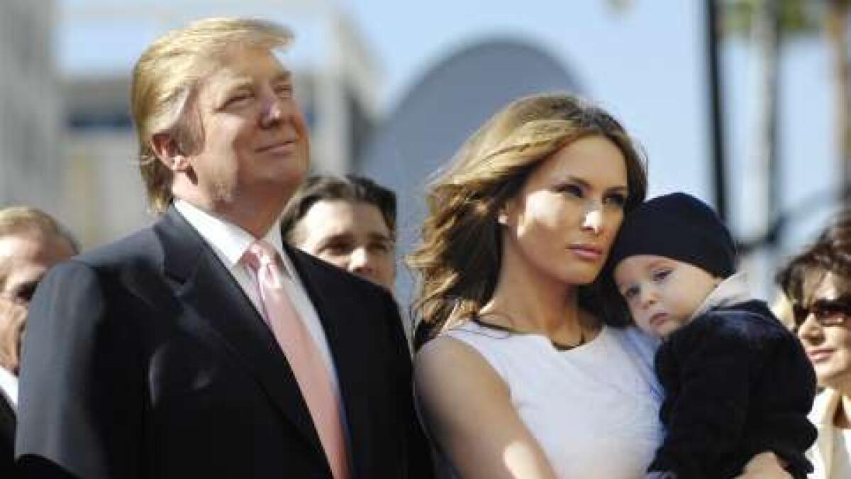 Donald Trump stands next to his wife Melania and their son Barron before he received a star on the Hollywood Walk of Fame in Los Angeles, January 16, 2007.
