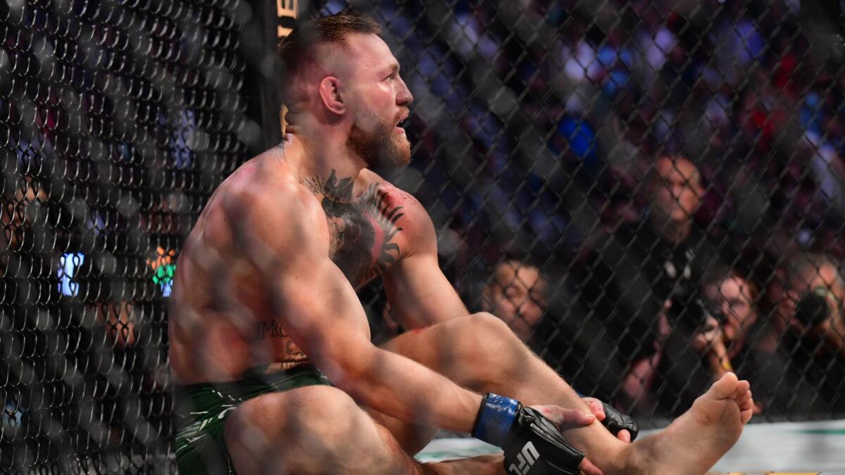 Conor McGregor reacts after suffering an injury in his loss to Dustin Poirier during UFC 264 at T-Mobile Arena. — Reuters
