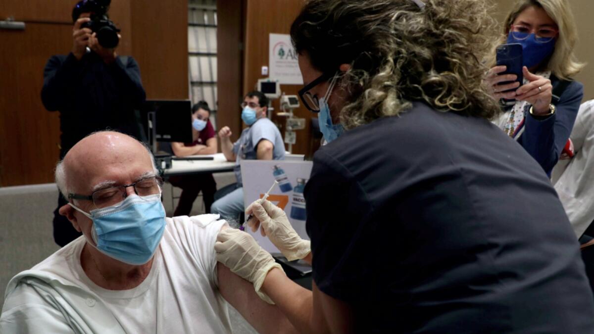 A healthcare worker receives Pfizer-BioNTech vaccine  at the American University Medical Center in Beirut, Lebanon. — AP