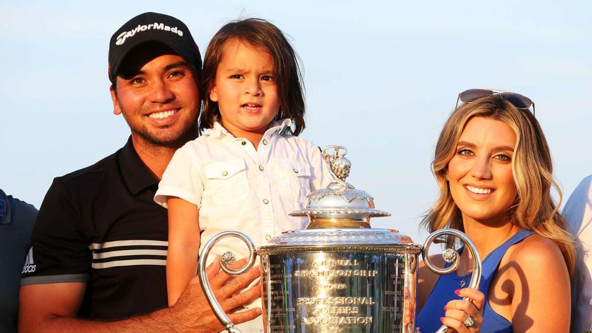 Jason Day with his wife Ellie and son Dash pose with the Wanamaker trophy after the Australian went on to win his first major title. 