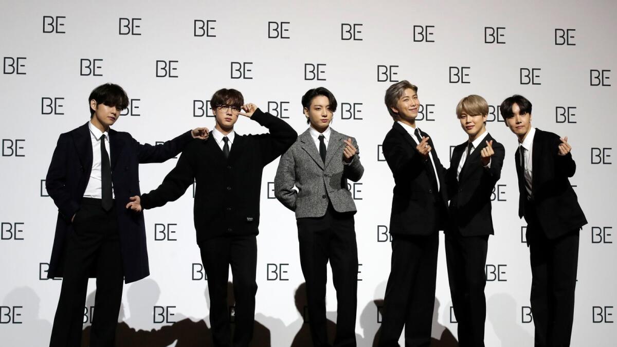 Members of South Korean K-Pop group BTS pose for photographers during a press conference to introduce their new album 'BE' in Seoul, South Korea, Friday, Nov. 20, 2020. (AP Photo/Lee Jin-man)