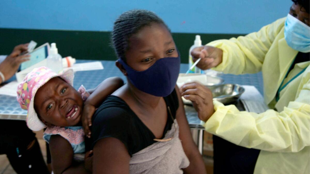 A baby cries as her mother receives her Pfizer vaccine against Covid-19, in Diepsloot Township near Johannesburg. — AP file