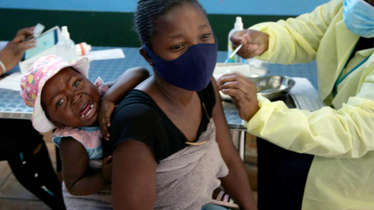 A baby cries as her mother receives her Pfizer vaccine against Covid-19, in Diepsloot Township near Johannesburg. — AP file