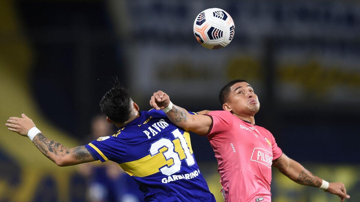 Mario Pineida (right) of Ecuador's Barcelona club and Cristian Pavon of Argentinian club Boca Juniors vie for the ball during the Copa Libertadores match in Buenos Aires on Thursday. (AFP)