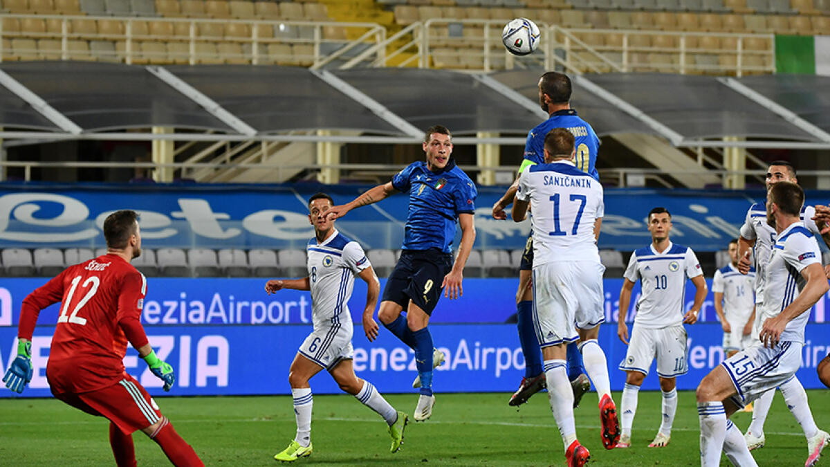 Italy's forward Andrea Belotti attempts a header during the Nations League match against Bosnia. -- AFP