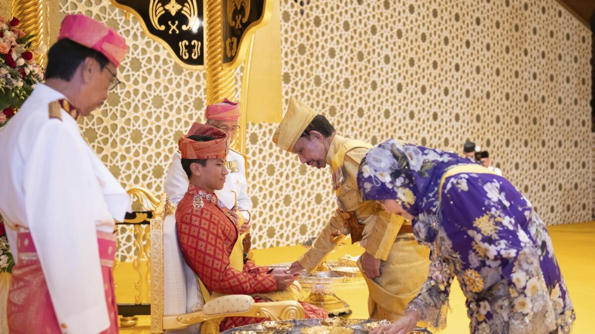 Brunei's Sultan Hassanal Bolkiah greets Prince Abdul Mateen during the royal powdering ceremony at Istana Nurul Iman in Bandar Seri Begawan. — AP