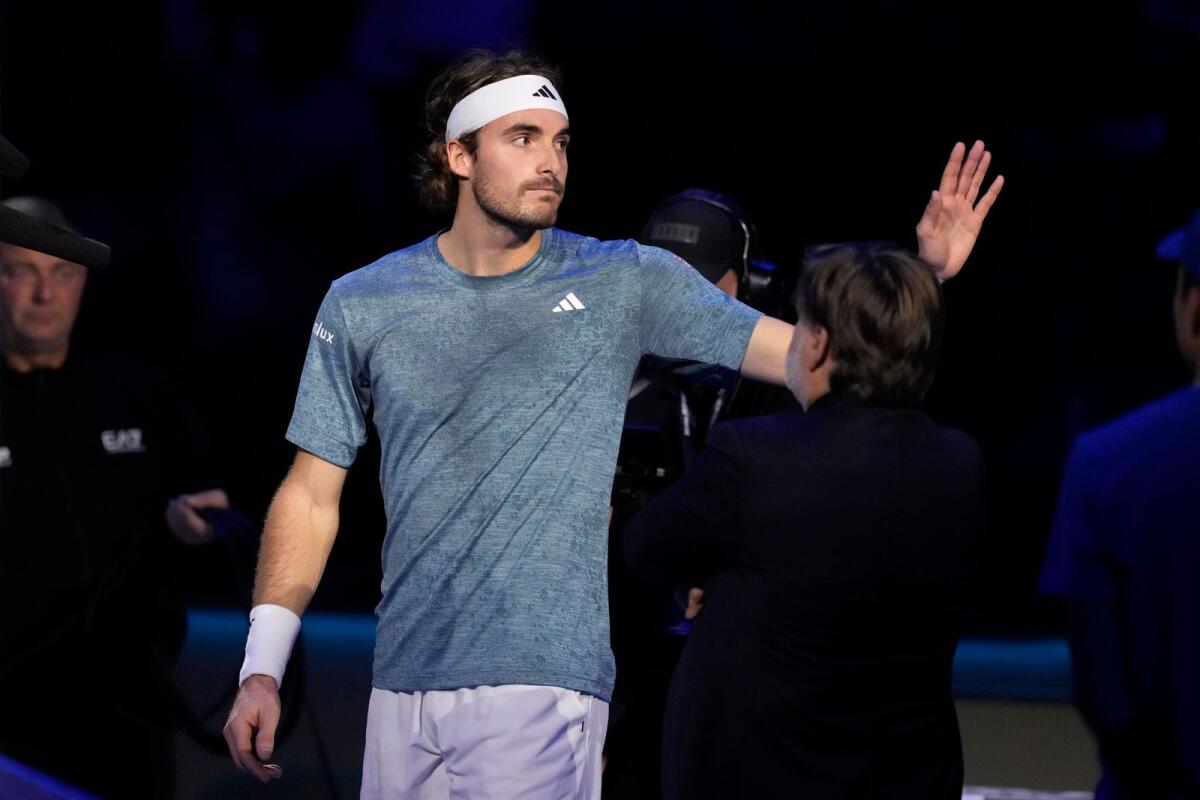 Stefanos Tsitsipas waves to supporters as he leaves the court. — AP
