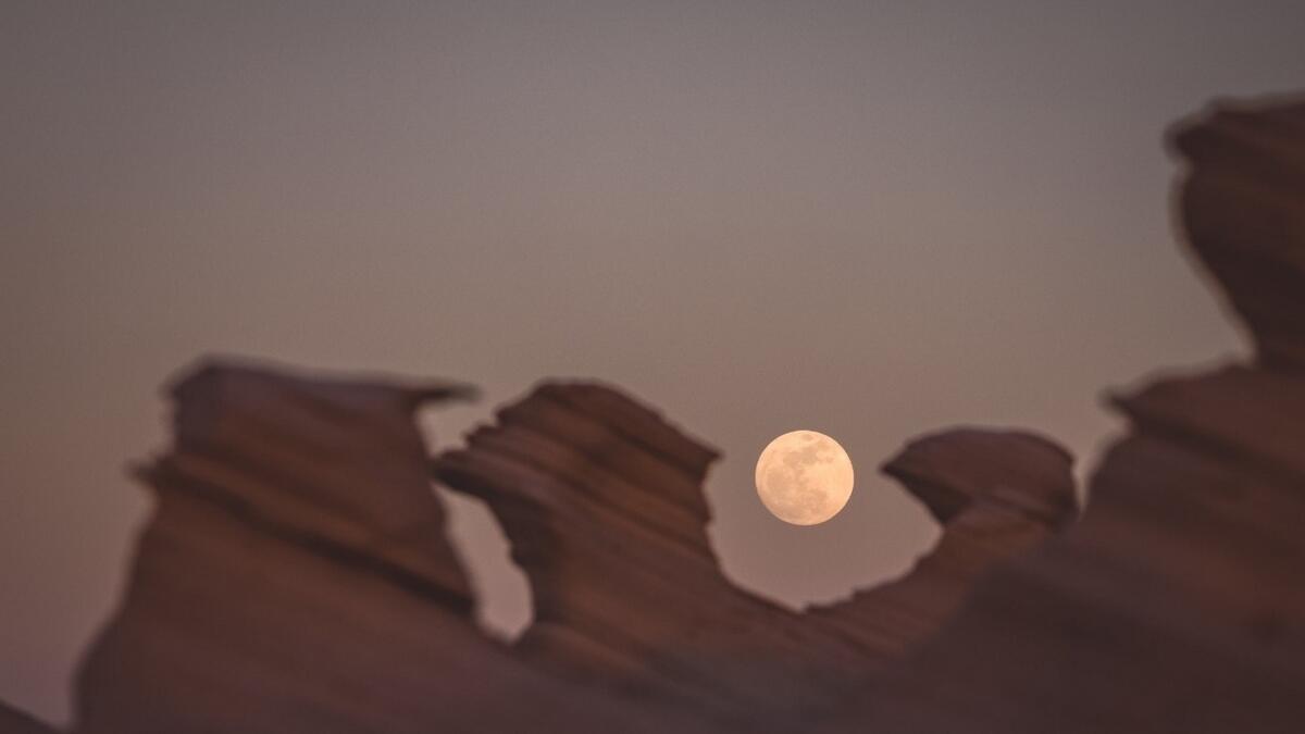 The moon rises behind Al Wathba fossil rocks in Abu Dhabi. Photo by Neeraj Murali