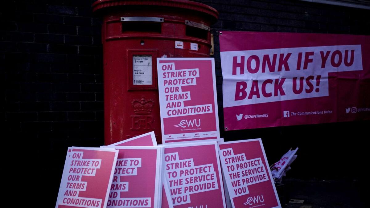 Placards piled up for postal workers from the Communication Workers Union (CWU) on the picket line at the Camden Town Delivery Office in north west London. — AP