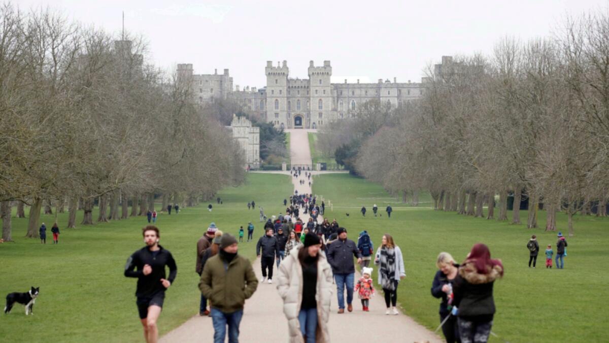 Windsor castle is seen as people walk on the Long Walk after the UK eased Covid-19 restrictions.— Reuters