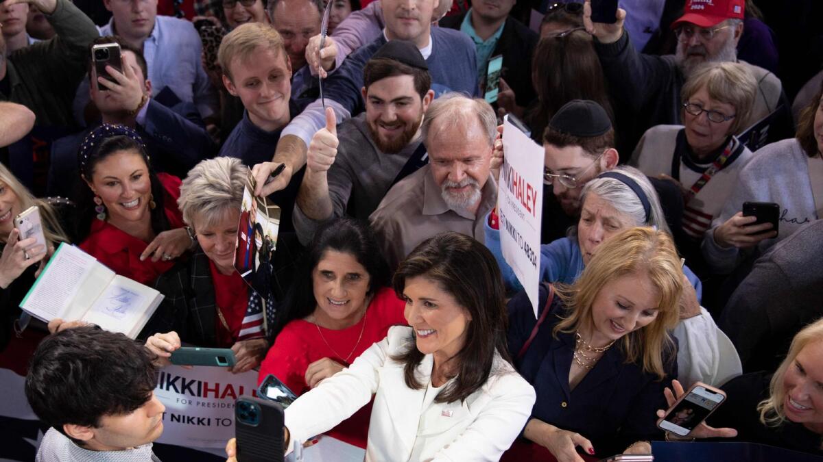 Former US ambassador to the UN Nikki Haley poses for a selfie with a crowd of supporters during a campaign event to launch her presidential bid, at the Charleston Visitor Center in Charleston, South Carolina. — AFP