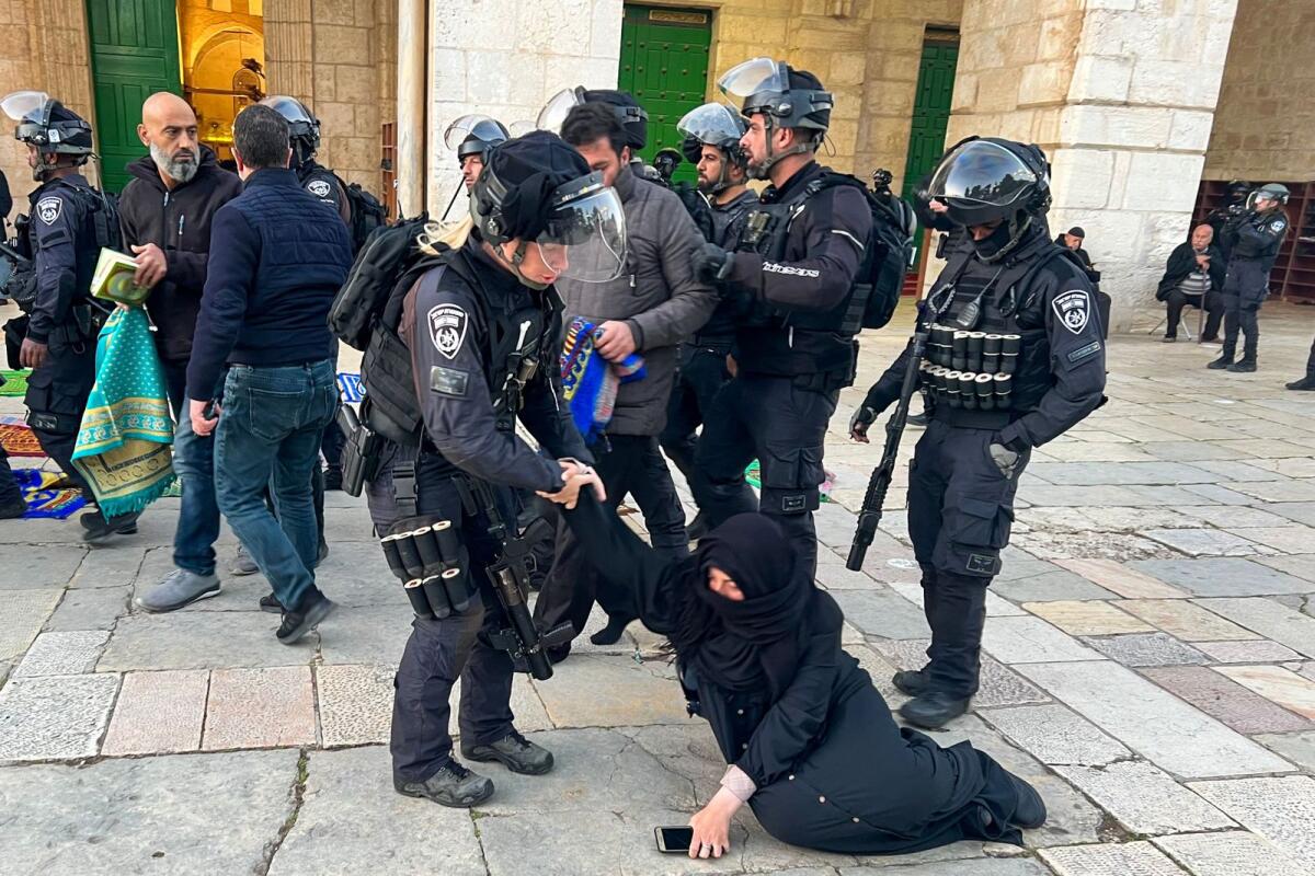 Israeli security forces remove Palestinian Muslim worshippers sitting on the grounds of the Al Aqsa mosque compound in Jerusalem, early on Wednesday during holy month of Ramadan. -- AFP