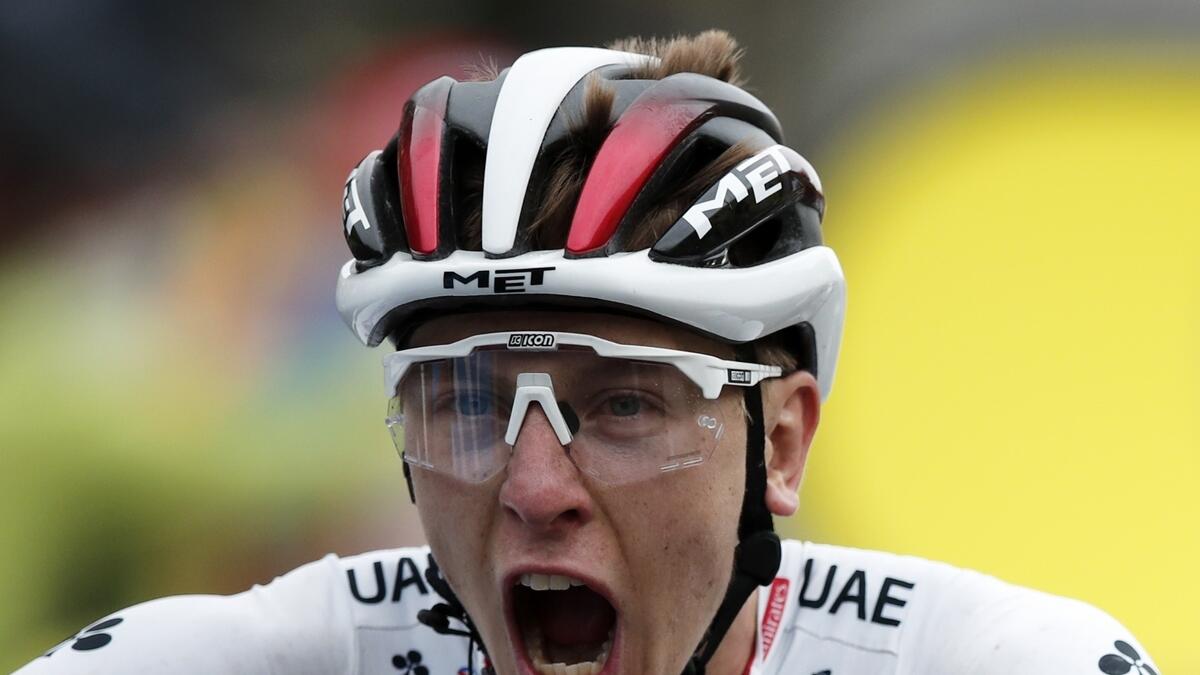 Tean UAE Emirates' Tadej Pogacar reacts as he crosses the finish line to win the ninth stage of the Tour de France