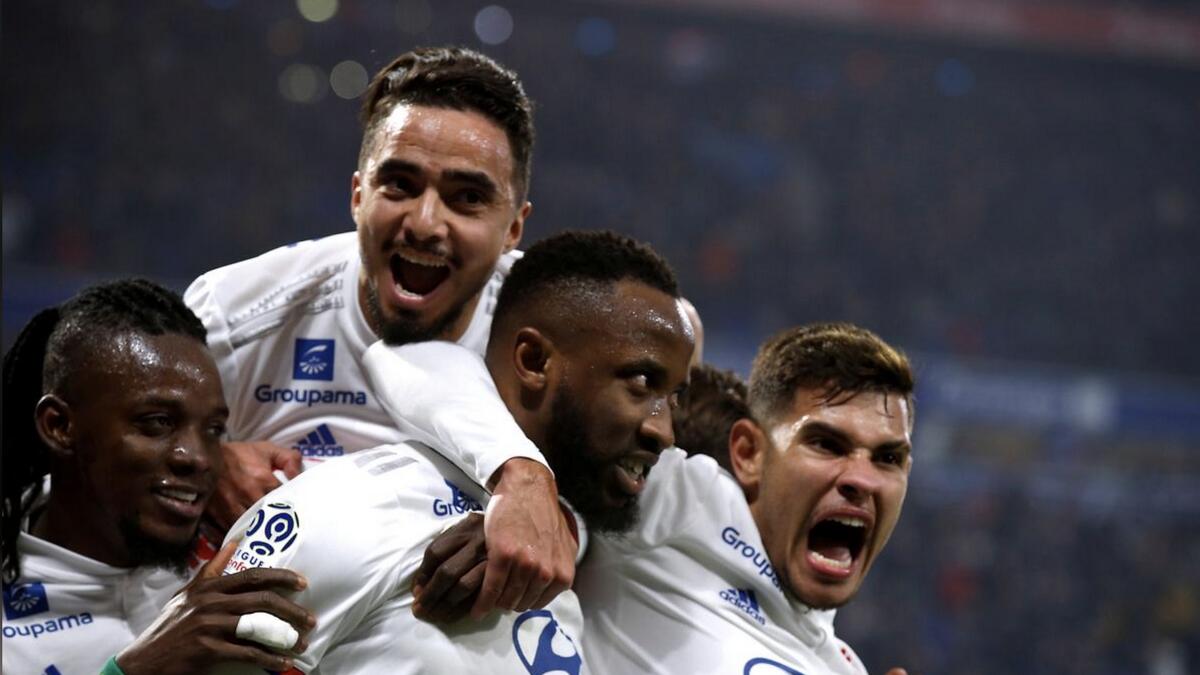Olympique Lyonnais' Moussa Dembele celebrates with teammates after scoring against AS Saint-Etienne in March. - Reuters file