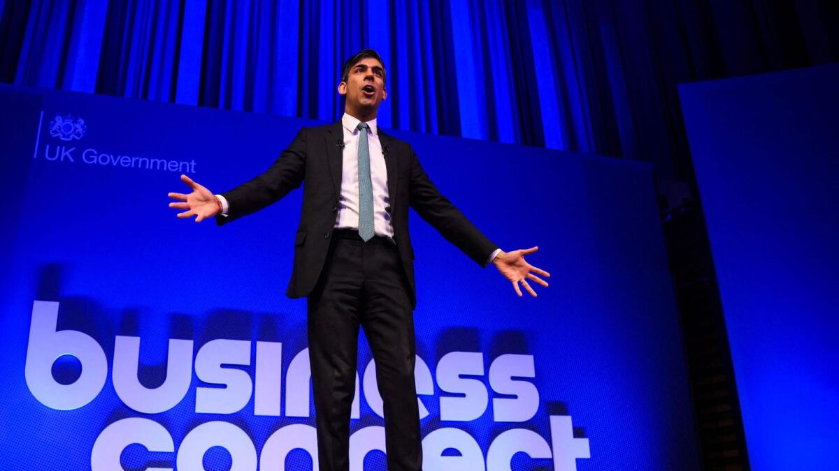 Britain's Prime Minister Rishi Sunak gestures as he delivers a speech on stage as he hosts a Business Connect event in North London, on Monday. — AFP