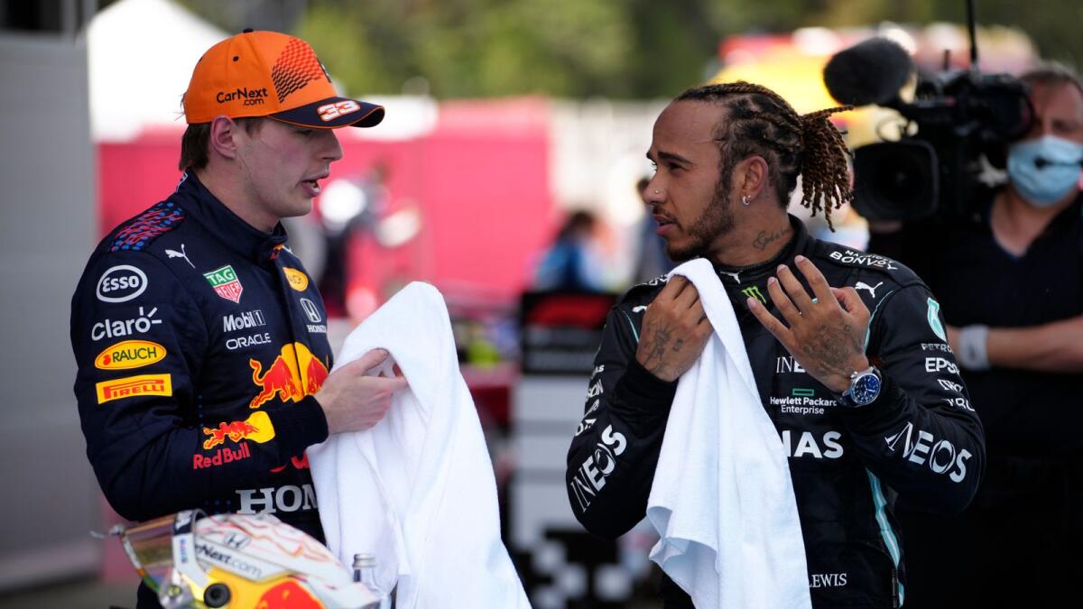 Mercedes driver Lewis Hamilton of Britain talks with second placed Red Bull driver Max Verstappen of the Netherlands after the Spanish Formula One Grand Prix. — AP