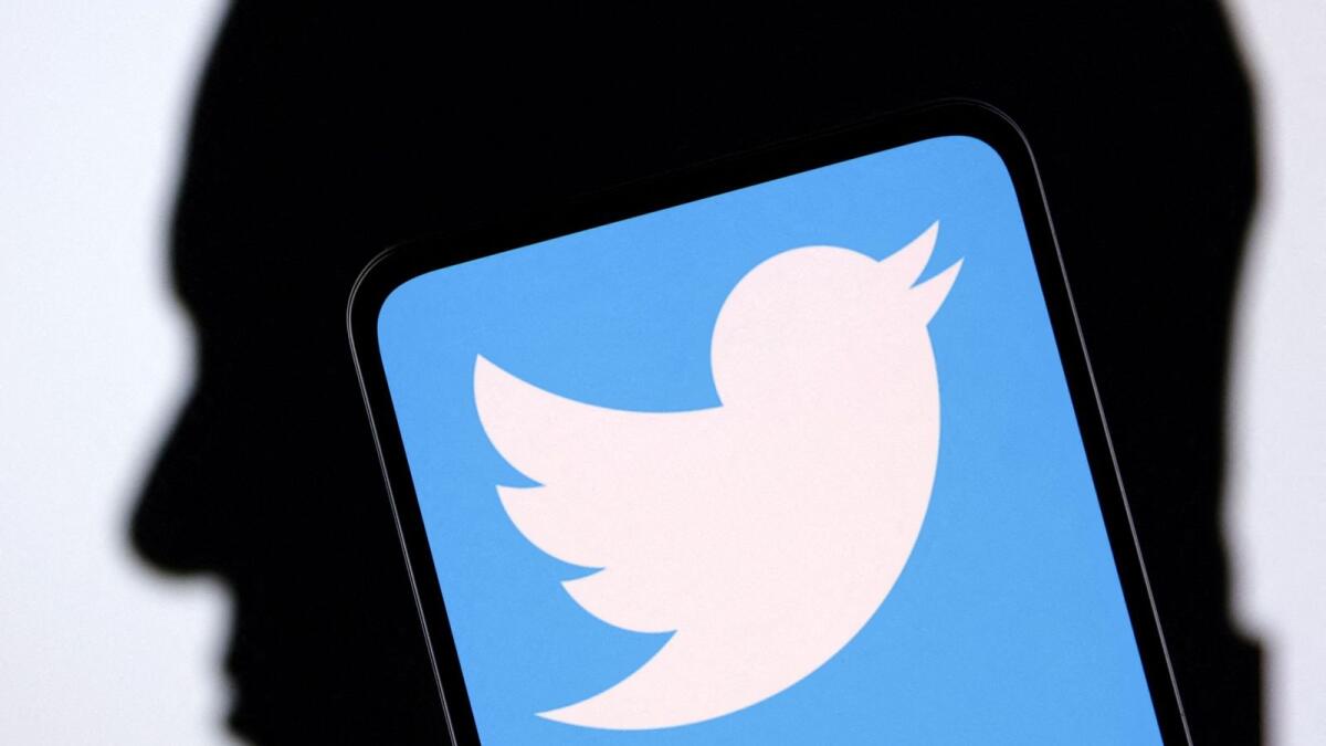 Twitter logo and Elon Musk silhouette are seen in this illustration taken  on December 19, 2022. — Reuters