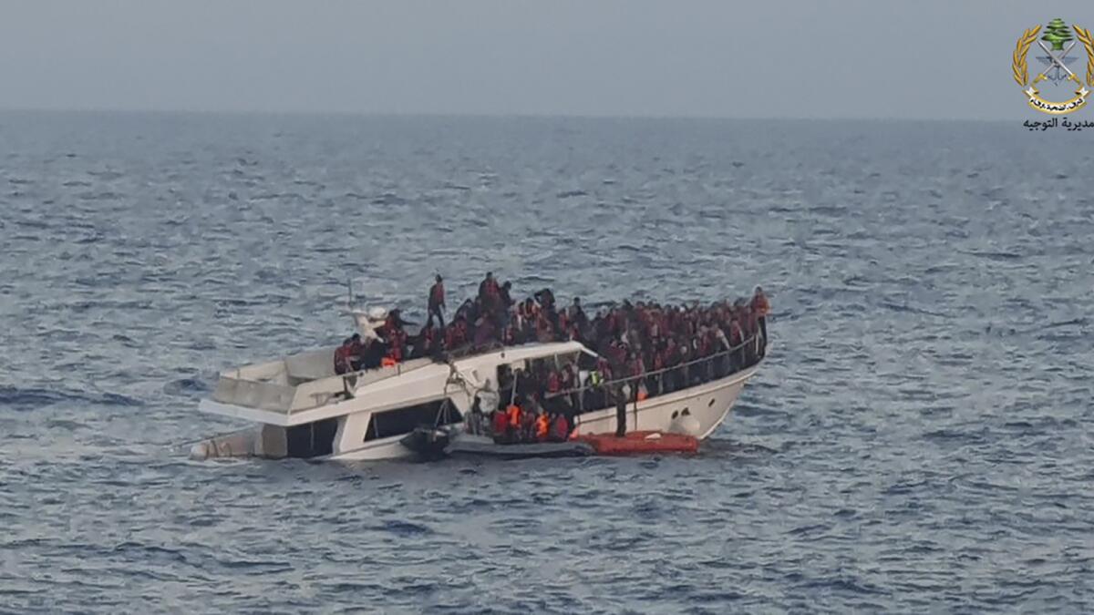 Lebanese army on their dinghy rescuing migrants from a boat near the shores of Tripoli, north Lebanon on Saturday. — AP