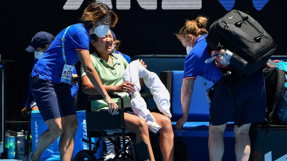 France's Harmony Tan receives assistance after retiring injured from her match against Ukraine's Elina Svitolina on Wednesday. — AFP
