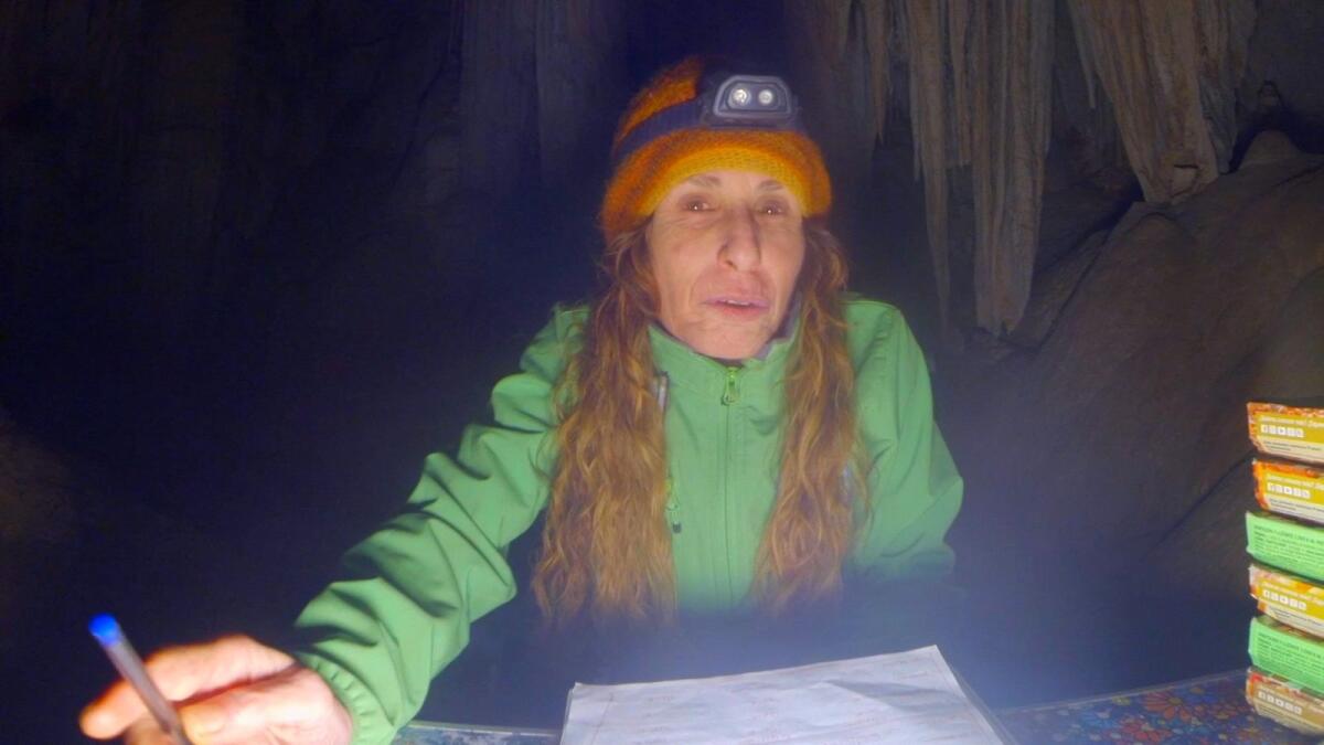 Beatriz Flamini, a Spanish mountaineer who has been isolated for 500 days in a cave is pictured during her daily life at the cave in Motril, Spain, in this screen grab taken from a handout video in November 2021. — Reuters