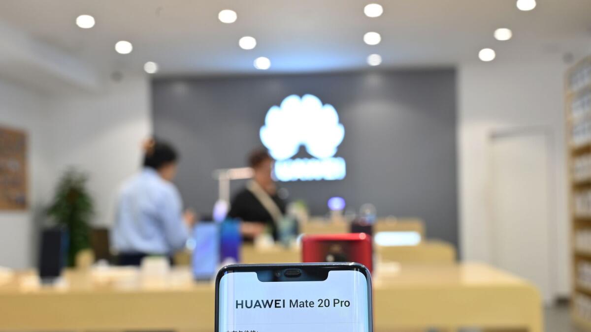 A Huawei smartphone is seen in a Huawei store in Shanghai. Recently, Huawei announced that it will charge mobile phone makers a royalty to use its patented 5G technology. — AFP file
